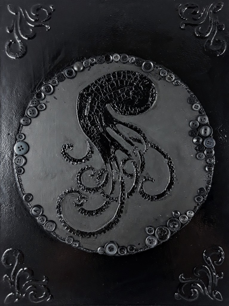 octopus in cracked stucco paste, in a cricle of buttons, with black varnish, black acrylic and stucco corner elements.